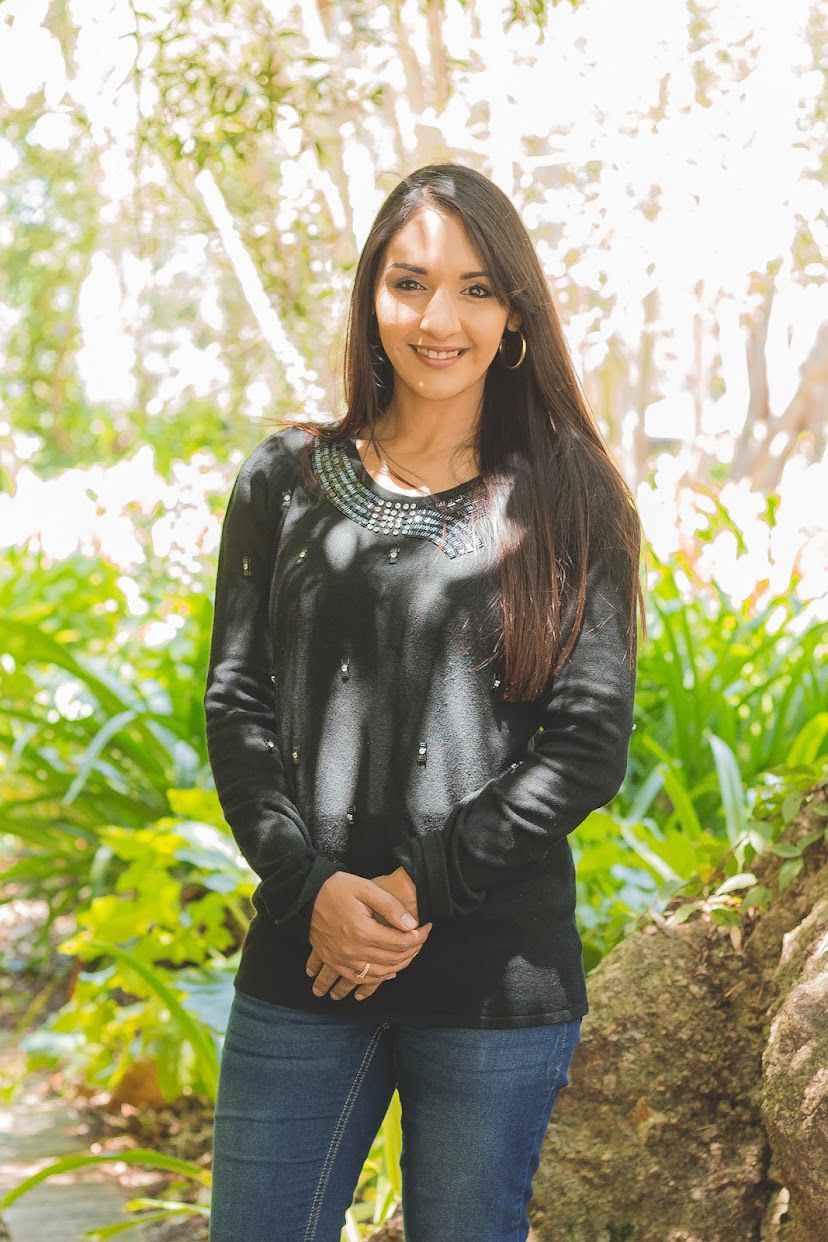 Teacher Najwa outdoors in a garden
