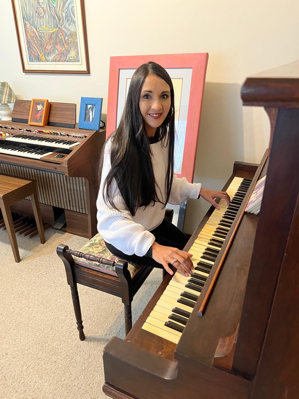 Teacher Najwa playing the piano